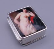 A silver pill box depicting a nude. 3 cm high.