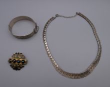 A silver necklace, a vintage silver bangle and a Victorian agate brooch.