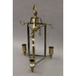 A triangular brass hanging light, lacking glass. 50 cm high.
