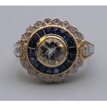 A 9 ct gold aquamarine, sapphire and diamond target ring. Ring size N.