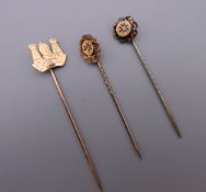 Two diamond set gold stick pins and a 9 ct gold stick pin.