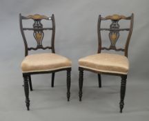 A pair of Victorian inlaid chairs. 45 cm wide.