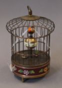 A cloisonne birdcage clock. 20 cm high.