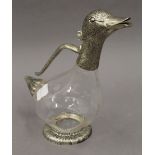 A novelty duck form claret jug. 26 cm high.
