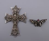 A Chester silver and paste butterfly brooch and a French unmarked white metal cross form pendant.