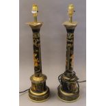 A pair of black toleware column lamps. 60 cm high.