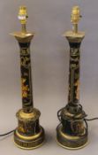 A pair of black toleware column lamps. 60 cm high.