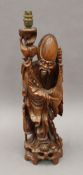 An early 20th century carved wooden table lamp formed as Shoa Loa. 59 cm high.