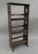 An Arts and Crafts mahogany book rack. 40.5 cm wide.