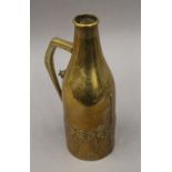 A W.M.F Arts and Crafts brass bottle cover. 29 cm high.