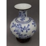 A Chinese blue and white porcelain vase on stand. 34 cm high.