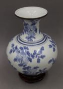 A Chinese blue and white porcelain vase on stand. 34 cm high.