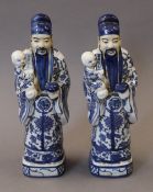 A pair of blue and white porcelain Chinamen. 31 cm high.