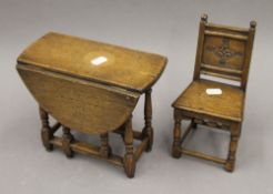 A miniature oak gate leg table and chair. The latter 22.5 cm high.