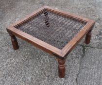 A modern Eastern coffee table. 108 cm long.