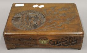 A late 19th/early 20th century carved pine box and an early 20th century Oriental carved wooden box.