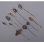 Ten vintage stick pins, including silver. The largest 8 cm long.