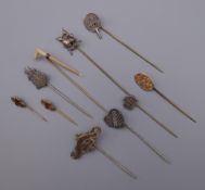 Ten vintage stick pins, including silver. The largest 8 cm long.