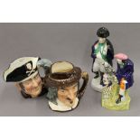 Two Royal Doulton character jugs together with two Staffordshire figures. The largest 28 cm high.