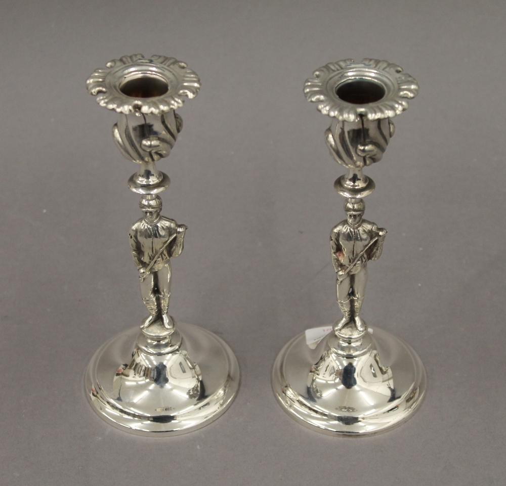 A pair of silver plated candlesticks formed as jockeys. 19.5 cm high.
