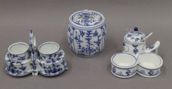 A blue and white porcelain cruet stand, a double egg cup stand and a lidded jar.