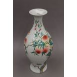 A Chinese peach decorated porcelain vase. 35 cm high.