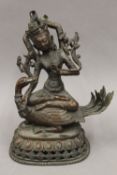 A Tibetan bronze figure of a Buddha astride a mythical bird. 29 cm high.