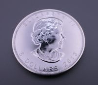 A silver 2013 Canadian 5 dollar coin.