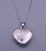 A 9 ct white gold locket on chain. 2 cm high.