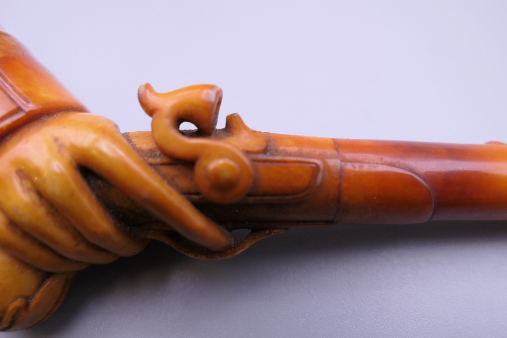 A cased 19th century meerschaum and amber pipe formed as a hand holding a pistol. 12 cm long. - Image 7 of 13