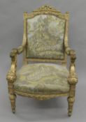 A tapestry covered 19th century carved gilt wood open armchair. 67.5 cm wide.