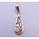 A 9 ct gold and diamond Brook & Bentley 'Garland of Love' teardrop pendant on a fine rope chain.