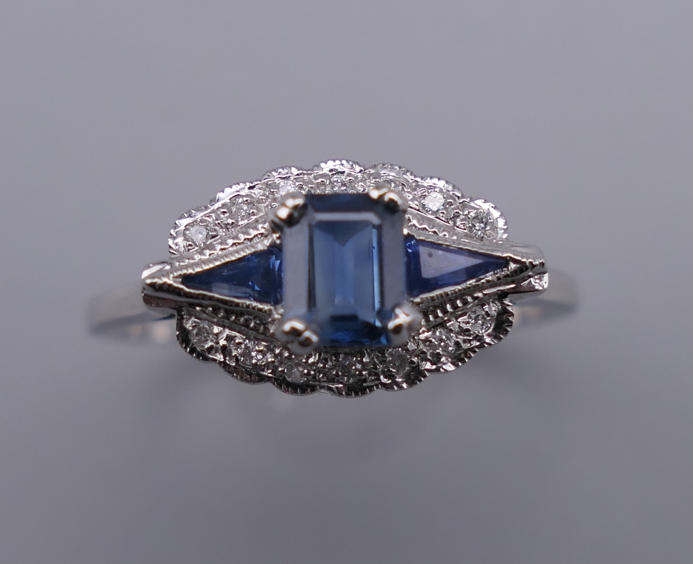 An Art Deco style 9 ct white gold sapphire and diamond ring. Ring size N/O.