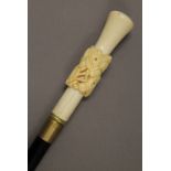 A bone handled horse head decorated walking stick. 98 cm long.