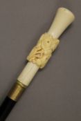 A bone handled horse head decorated walking stick. 98 cm long.