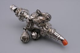 An antique silver child's rattle of typical form with bells and a whistle,