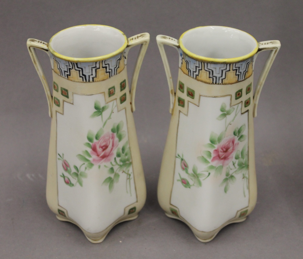 A pair of Japanese porcelain vases decorated with roses. 17.5 cm high.