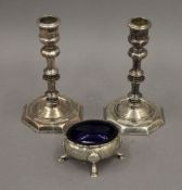 A Georgian silver salt and a pair of plated candlesticks. The former 8 cm wide.