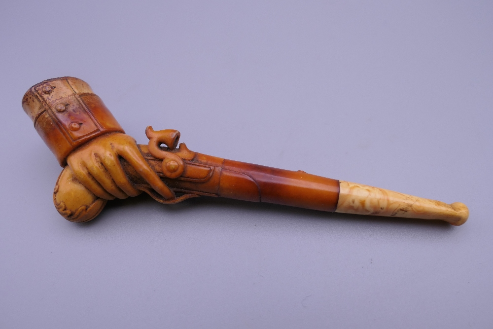 A cased 19th century meerschaum and amber pipe formed as a hand holding a pistol. 12 cm long. - Image 2 of 13