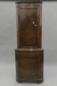 A burr walnut corner cupboard. 179 cm high.