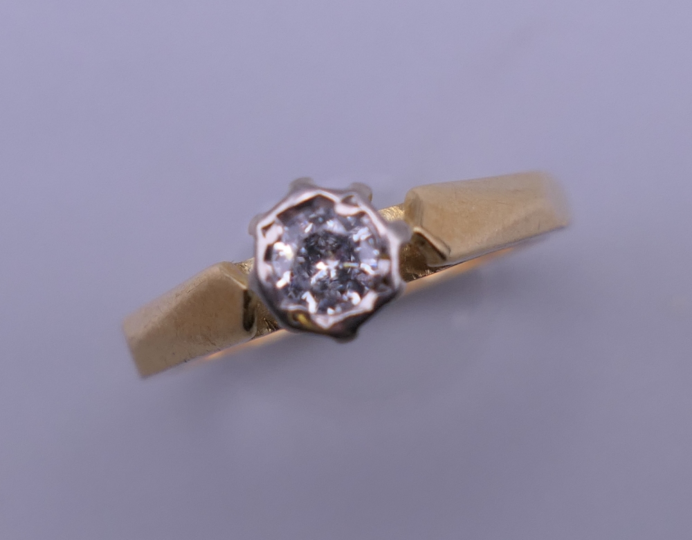 An 18 K gold diamond solitaire ring. Ring size L/M.
