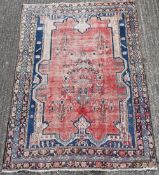 A red ground wool rug. 150 x 210 cm.