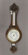 An early 20th century oak barometer. 70 cm high.
