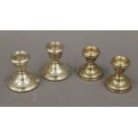 Two pairs of silver dwarf candlesticks. The largest 6.5 cm high. 11.2 troy ounces loaded.