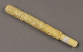 A bone carved cigar holder. 23 cm long.