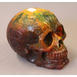 A model of a skull. 12.5 cm high.