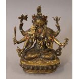 A gilt bronze multi-armed deity set with coral and turquoise. 21.5 cm high.