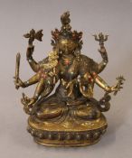 A gilt bronze multi-armed deity set with coral and turquoise. 21.5 cm high.