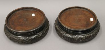 A pair of 19th century Chinese carved wooden, possibly Hongmu urn stands. 27 cm diameter.