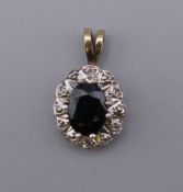 A 9 ct gold sapphire and diamond pendant. 1.75 cm high.